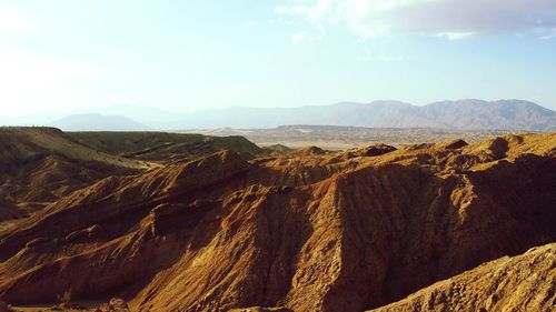 Scenic view of dry rock bed against sky