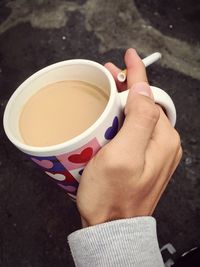 Close-up of hand holding coffee cup