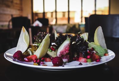 Close-up of fruits in plate on table