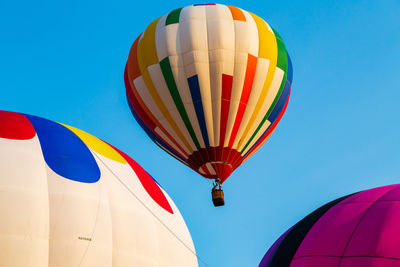 Low angle view of hot air balloon against blue sky