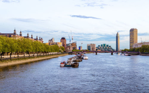 Boats in river with buildings in background