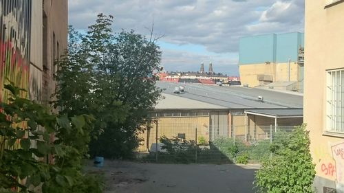 Buildings in city against cloudy sky