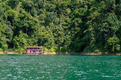 Houseboat crusing through the lake with mountain view at kenyir lake.