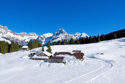 Snow covered mountain against clear blue sky