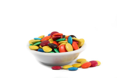 Close-up of multi colored candies against white background