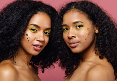 Close-up portrait of female friends with curly hair