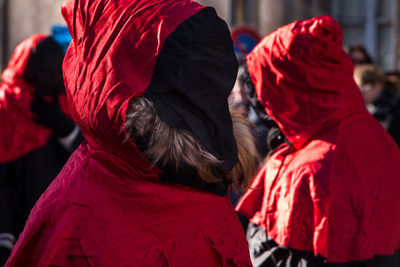 People wearing red costume in city