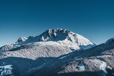 Scenic view of snowcapped mountains against clear blue sky