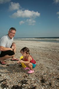 Full length of grandfather with grandson at beach against sky