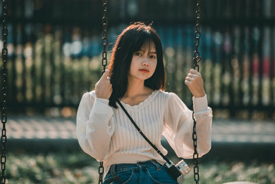 Portrait of young woman standing outdoors