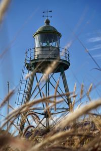 Low angle view of water lighthouse sky