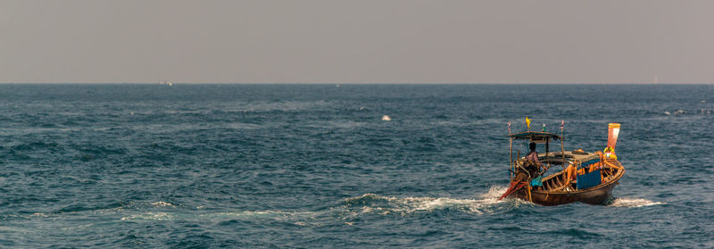 View of ship in sea against clear sky