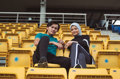 Portrait of a smiling young man sitting on seat