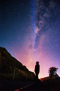 Silhouette man standing against sky at night