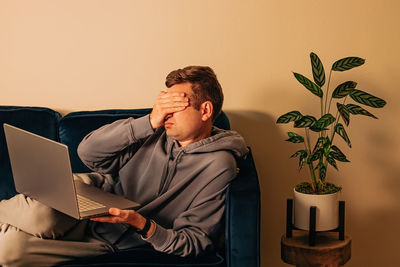 Young woman using laptop at home