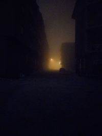 Silhouette buildings against sky at night