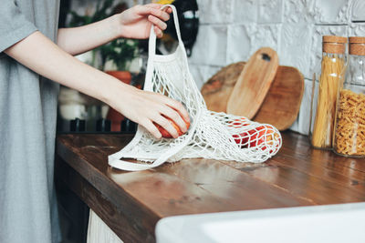 Midsection of woman holding table