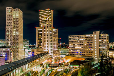 High angle view of illuminated buildings against sky at night
