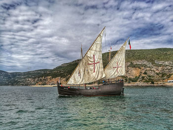 Sailboat sailing on sea against sky