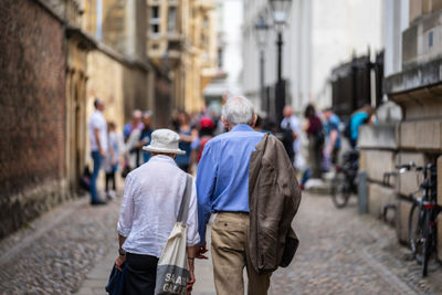 Rear view of people walking on street