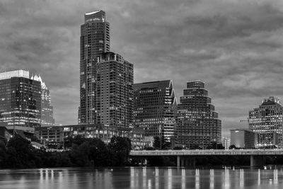 Modern buildings by city against sky