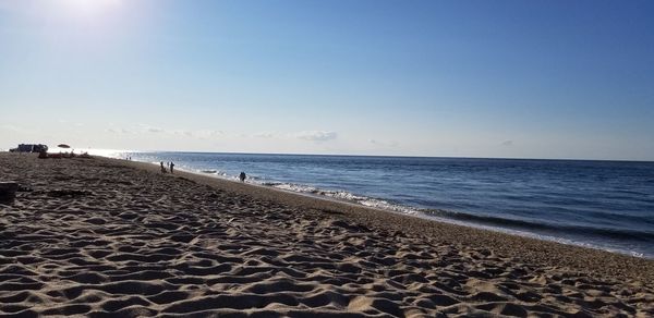 Scenic view of beach against clear sky