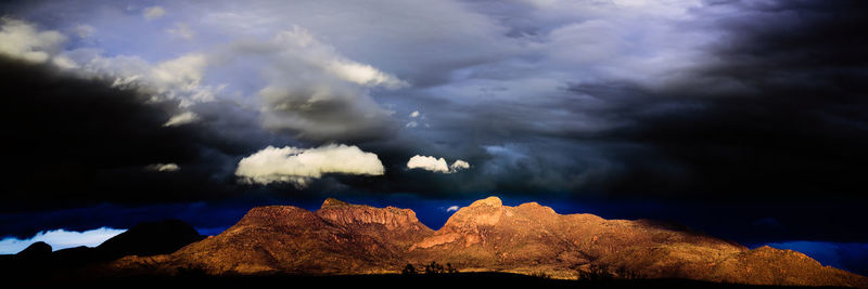 Scenic view of mountains against cloudy sky