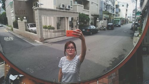 Woman taking a picture of herself with a mobile phone