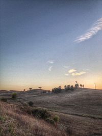 Scenic view of landscape against sky at sunset