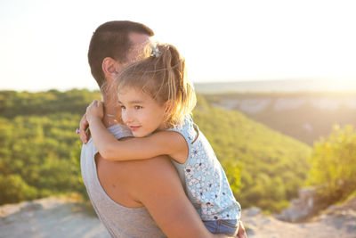 Midsection of mother and baby girl on land