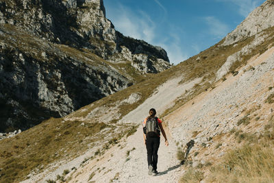 Full length of man standing on mountain against sky