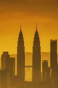 Silhouette of buildings against sky during sunset