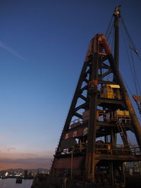 Low angle view of crane against clear sky