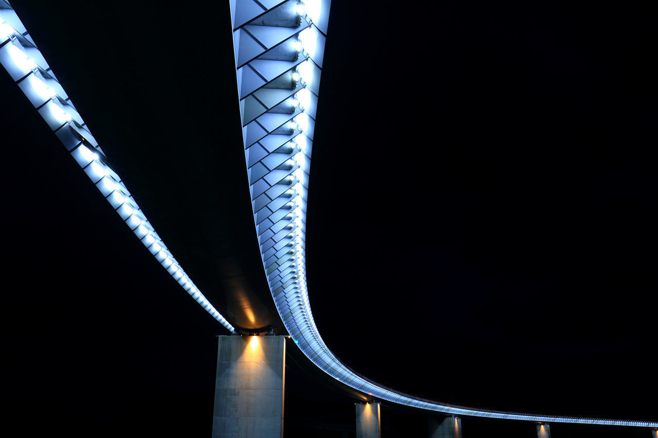 LOW ANGLE VIEW OF ILLUMINATED BRIDGE AGAINST SKY