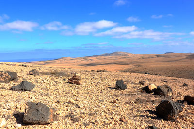 Scenic view of arid landscape against sky