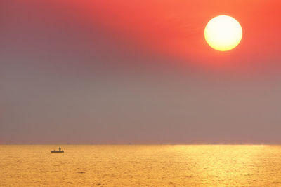 Scenic view of sea against clear sky during sunset