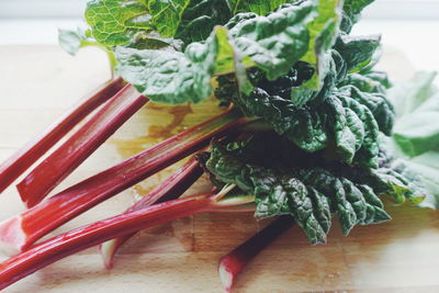 Directly above shot of rhubarb leaves on cutting board