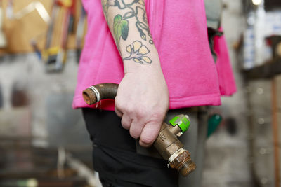 Plumber's hands holding pipe