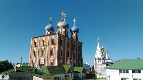 Low angle view of buildings against blue sky