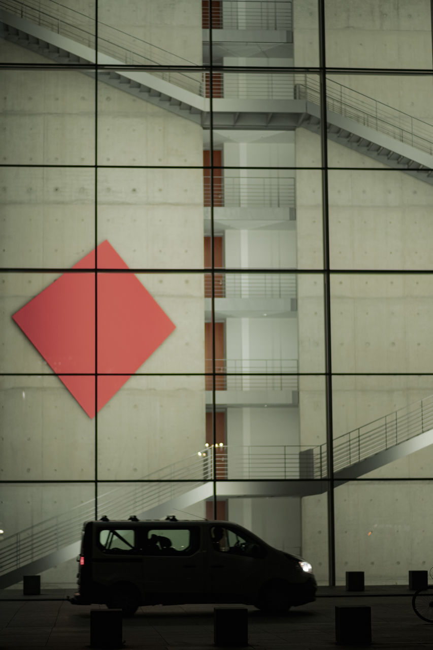 ROAD SIGN AGAINST BUILDING