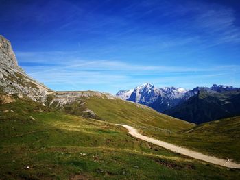 Scenic view of snowcapped mountains against blue sky