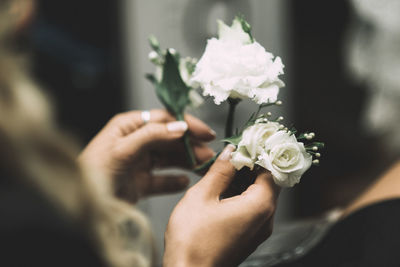 Cropped hands of woman holding roses