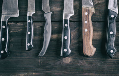 Directly above view of knives on wooden table