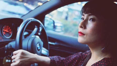 Close-up portrait of woman in car