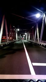 Illuminated bridge at night