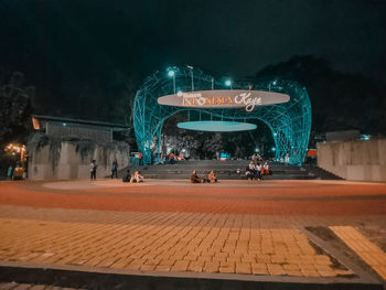 Group of people in illuminated building at night