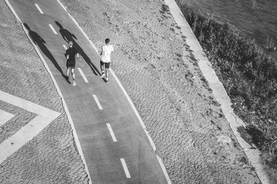 High angle view of people walking on road