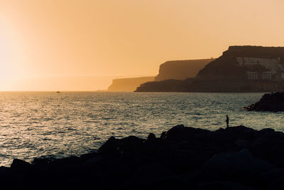 Scenic view of sea against clear sky during sunset