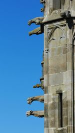 Low angle view of statue against blue sky