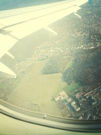 Aerial view of city seen through airplane window